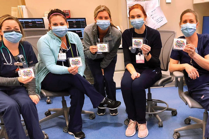 nurses holding up cookies