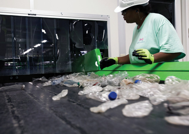 woman working in plastic bottle recycling facility