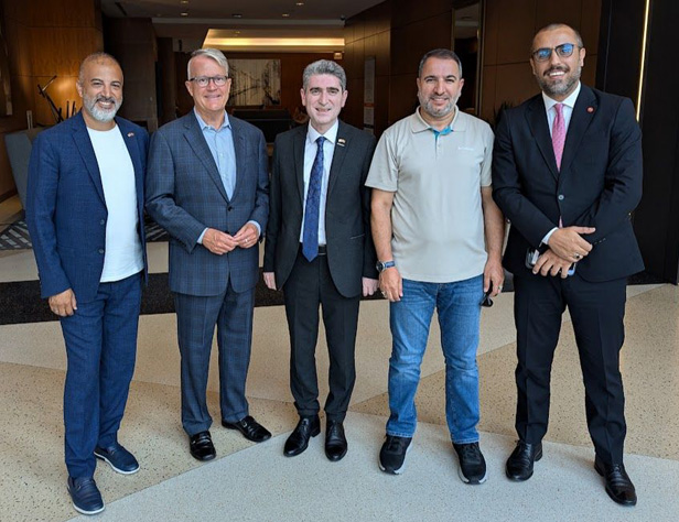 group of five men smiling men