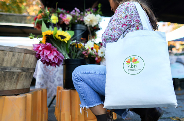 woman holding reusable tote bag